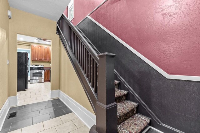44 Pasadena St, Mt Washington, PA 15211 - stairway featuring baseboards and tile patterned flooring