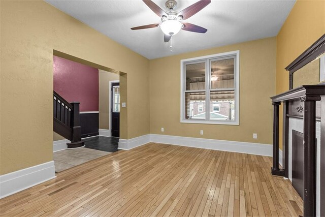 44 Pasadena St, Mt Washington, PA 15211 - unfurnished living room with ceiling fan, hardwood / wood-style flooring, stairway, a fireplace, and baseboards