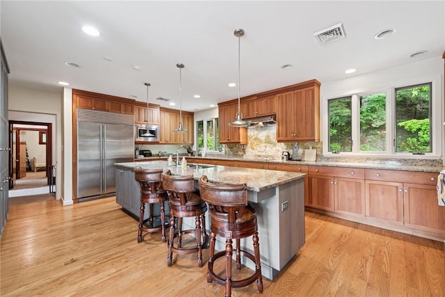 428 Jefferson School Rd, Cook Twp, PA 15658 - kitchen featuring built in appliances, light wood-style floors, under cabinet range hood, light stone counters, and recessed lighting
