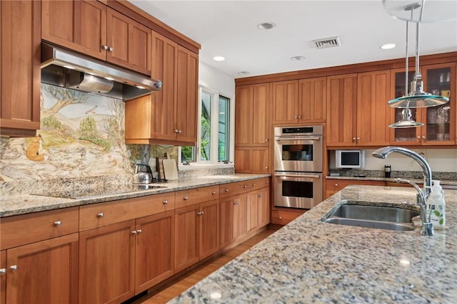 428 Jefferson School Rd, Cook Twp, PA 15658 - kitchen featuring stainless steel double oven, under cabinet range hood, a sink, black electric cooktop, and light wood-style floors