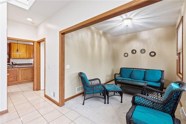 704 Park Ave, Rostraver, PA 15012 - living room with baseboards, light tile patterned floors, and a skylight