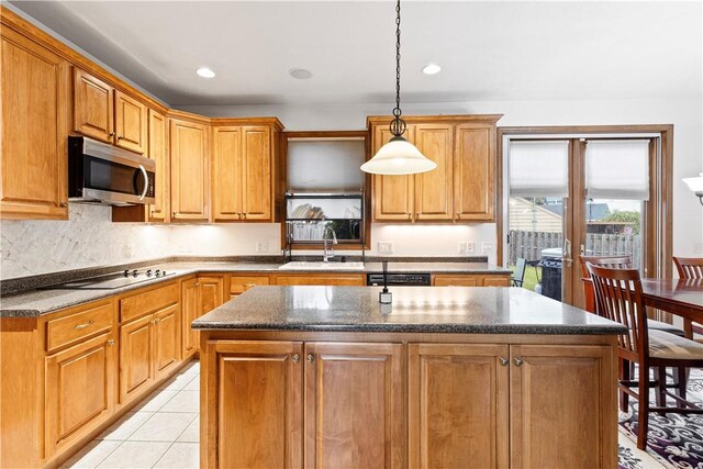 704 Park Ave, Rostraver, PA 15012 - kitchen featuring black appliances, a sink, a kitchen island, pendant lighting, and light tile patterned flooring