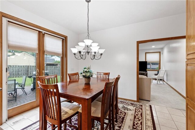 704 Park Ave, Rostraver, PA 15012 - dining area featuring a chandelier, light tile patterned floors, baseboards, and light carpet