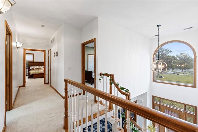 704 Park Ave, Rostraver, PA 15012 - corridor with an upstairs landing, light colored carpet, baseboards, and a chandelier
