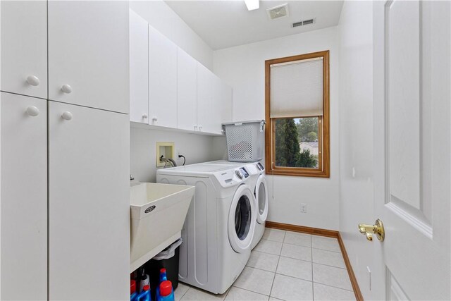 704 Park Ave, Rostraver, PA 15012 - washroom featuring cabinet space, washing machine and clothes dryer, light tile patterned floors, and baseboards