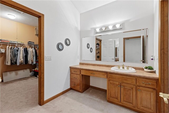 704 Park Ave, Rostraver, PA 15012 - bathroom featuring vanity, a spacious closet, and baseboards