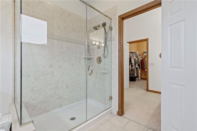 704 Park Ave, Rostraver, PA 15012 - bathroom featuring a shower stall, a walk in closet, tile patterned floors, and baseboards
