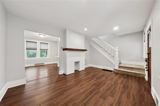 1110 Illinois Ave, Dormont, PA 15216 - unfurnished living room featuring a brick fireplace, wood finished floors, stairs, baseboards, and recessed lighting