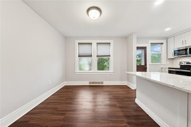 1110 Illinois Ave, Dormont, PA 15216 - kitchen with stainless steel appliances, light stone countertops, baseboards, dark wood-style floors, and white cabinets