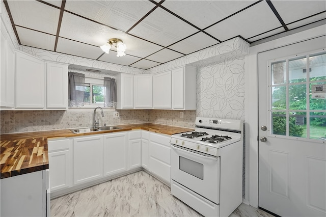 2735 20th Street Ext, Patterson Twp, PA 15010 - kitchen featuring butcher block counters, white gas range, a sink, white cabinetry, and decorative backsplash