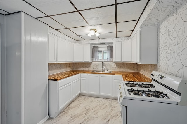 2735 20th Street Ext, Patterson Twp, PA 15010 - kitchen with gas range gas stove, a sink, wood counters, and white cabinetry