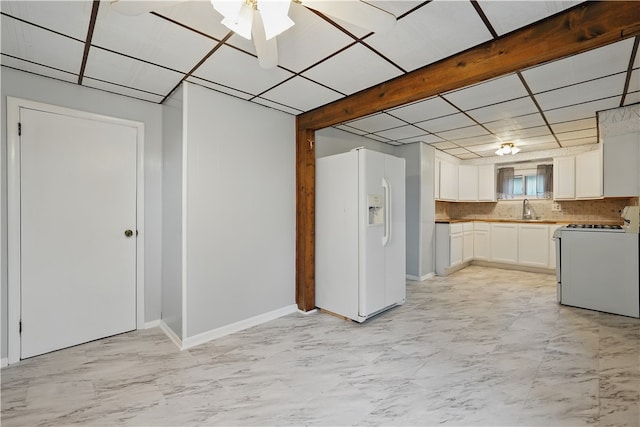 2735 20th Street Ext, Patterson Twp, PA 15010 - kitchen with white appliances, a sink, white cabinets, light marble finish flooring, and baseboards