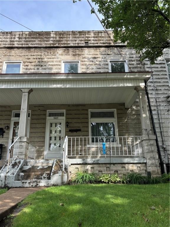 7027 Blackhawk St, Swissvale, PA 15218 - view of front of home featuring a porch and a front lawn
