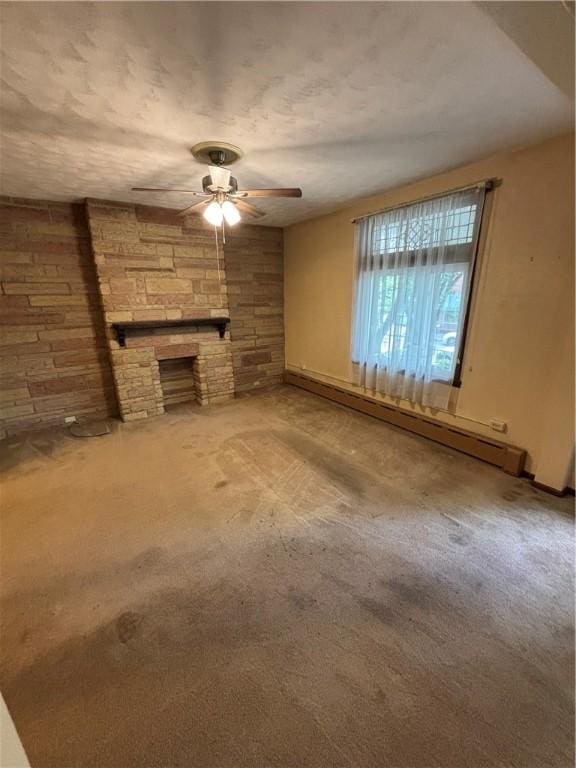 7027 Blackhawk St, Swissvale, PA 15218 - unfurnished living room featuring baseboard heating, ceiling fan, carpet flooring, and a stone fireplace