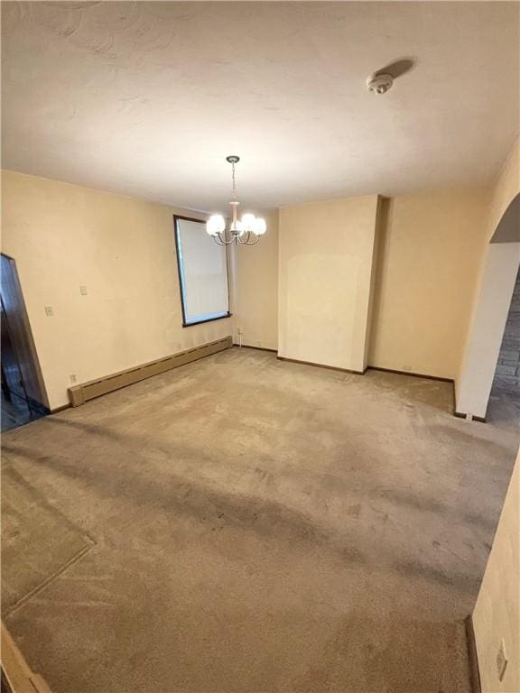 7027 Blackhawk St, Swissvale, PA 15218 - spare room with a baseboard radiator, light carpet, and a chandelier