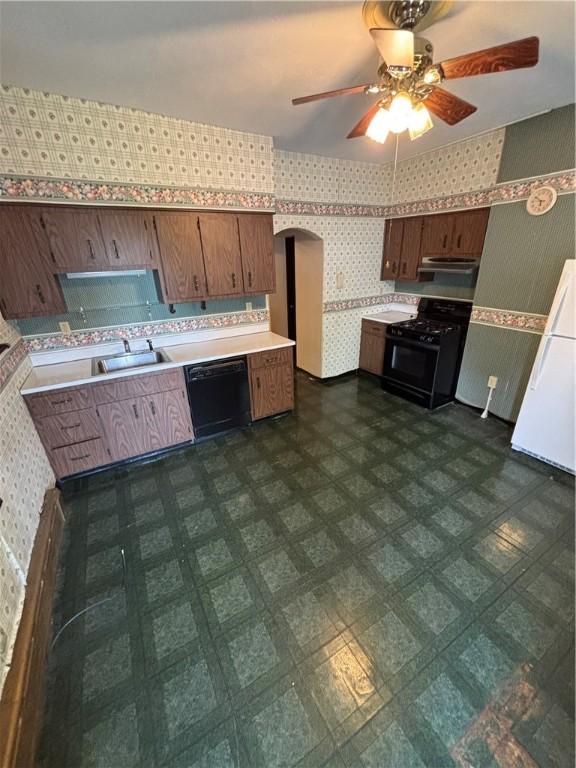 7027 Blackhawk St, Swissvale, PA 15218 - kitchen featuring black appliances, wallpapered walls, a sink, light countertops, and a ceiling fan