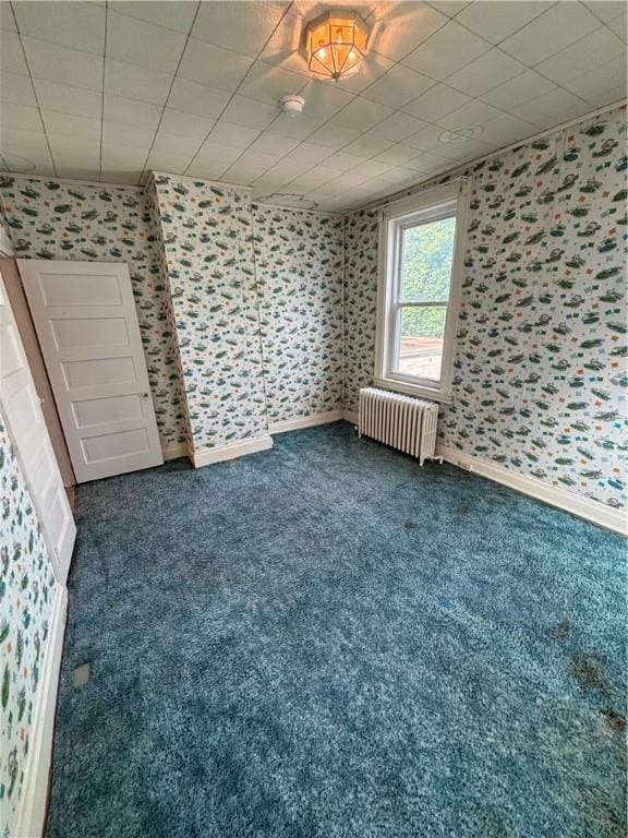 7027 Blackhawk St, Swissvale, PA 15218 - carpeted empty room with radiator, wallpapered walls, baseboards, and a smoke detector