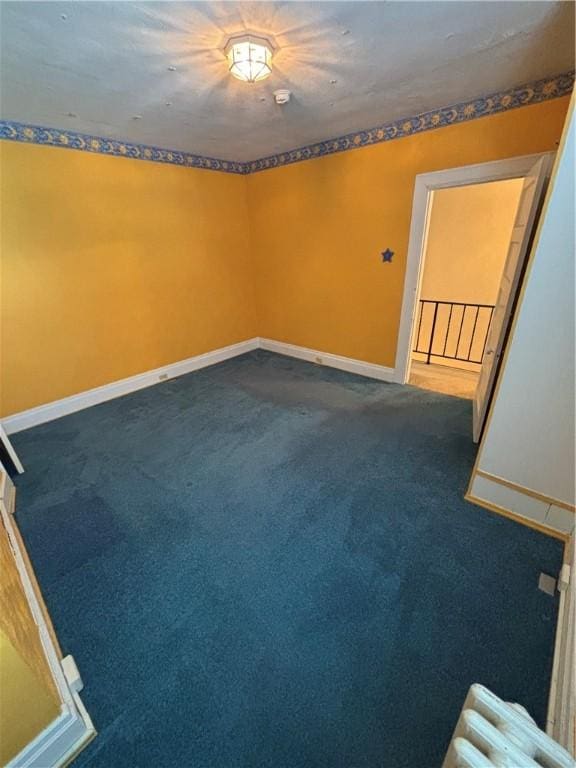 7027 Blackhawk St, Swissvale, PA 15218 - empty room with dark carpet and baseboards