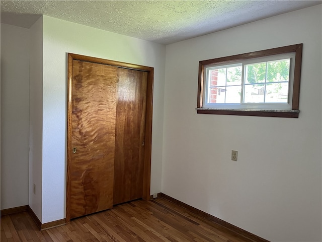 100 Rohaley Ln, Menallen Twp, PA 15480 - unfurnished bedroom featuring wood finished floors, baseboards, a closet, and a textured ceiling