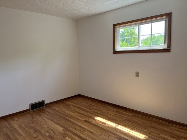 100 Rohaley Ln, Menallen Twp, PA 15480 - unfurnished room featuring wood finished floors, baseboards, and a textured ceiling