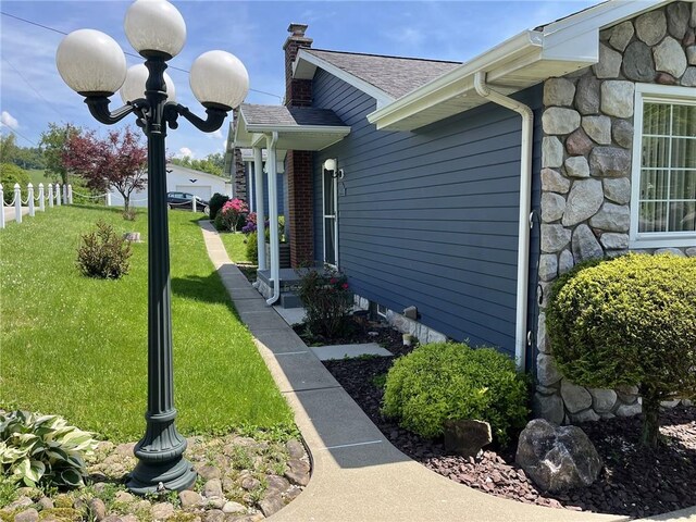 100 Rohaley Ln, Menallen Twp, PA 15480 - view of home's exterior featuring a chimney, stone siding, and a shingled roof