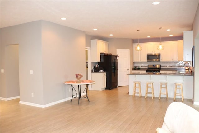 127 Benton, Canonsburg, PA 15317 - kitchen with stainless steel appliances, recessed lighting, a peninsula, light wood finished floors, and backsplash