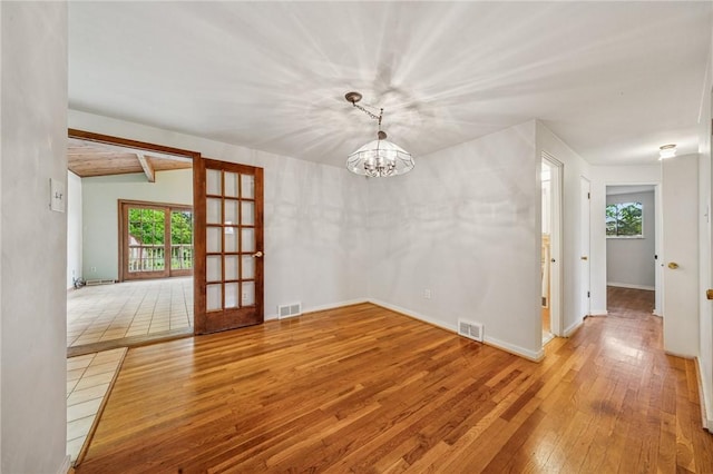 1371 Blue Jay Dr, Scott Twp Sal, PA 15243 - unfurnished room featuring hardwood / wood-style floors, a chandelier, french doors, and baseboards