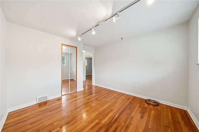 1371 Blue Jay Dr, Scott Twp Sal, PA 15243 - spare room with baseboards, light wood-type flooring, and rail lighting