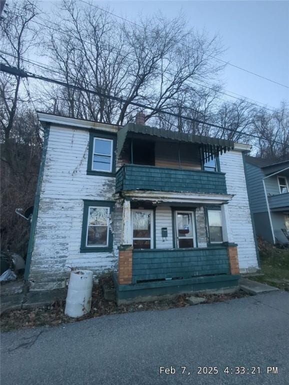 1125 Stowe Ave, Mckees Rocks, PA 15136 - view of front of home with a balcony and a chimney