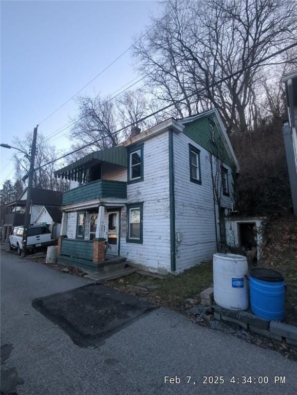 1125 Stowe Ave, Mckees Rocks, PA 15136 - view of front of house with a balcony and a chimney