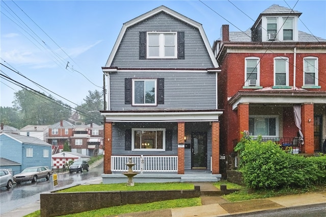 134 Poplargrove St, Carrick, PA 15210 - view of front of home with covered porch, a gambrel roof, and brick siding