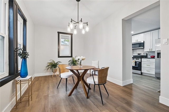 134 Poplargrove St, Carrick, PA 15210 - dining room featuring wood finished floors, baseboards, and a chandelier