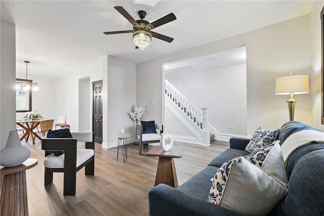 134 Poplargrove St, Carrick, PA 15210 - living room featuring wood finished floors, stairway, a ceiling fan, and baseboards