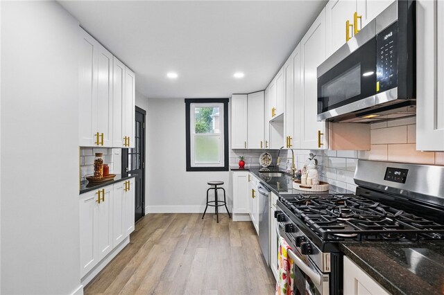 134 Poplargrove St, Carrick, PA 15210 - kitchen featuring appliances with stainless steel finishes, baseboards, light wood-style flooring, white cabinetry, and recessed lighting