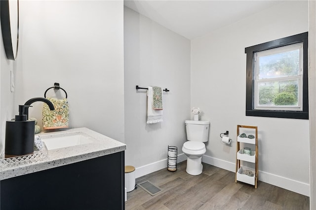 134 Poplargrove St, Carrick, PA 15210 - bathroom featuring vanity, toilet, wood finished floors, and baseboards