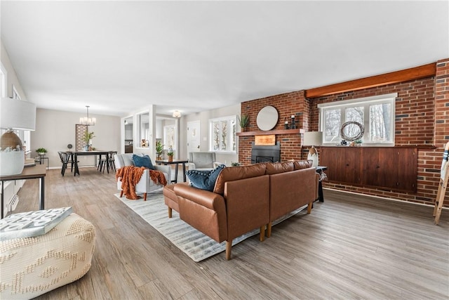 385 Vogan Dr, Mercer Boro Mer, PA 16137 - living room featuring a fireplace, light wood-type flooring, and a chandelier