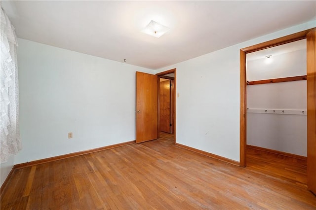 173 Mcintyre Rd, Ross Twp, PA 15237 - unfurnished bedroom featuring light wood-style flooring, a closet, and baseboards
