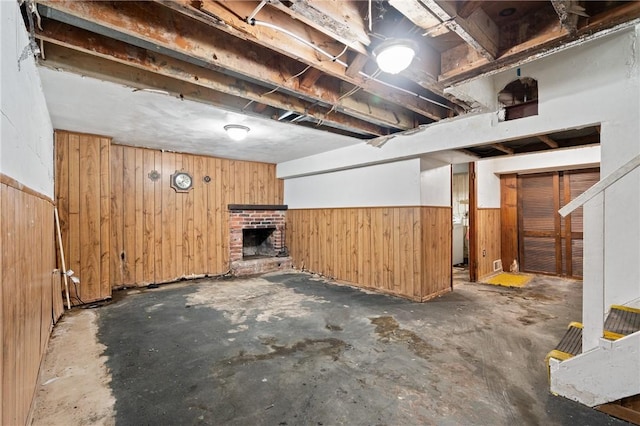 173 Mcintyre Rd, Ross Twp, PA 15237 - unfinished basement featuring wood walls, a brick fireplace, and wainscoting