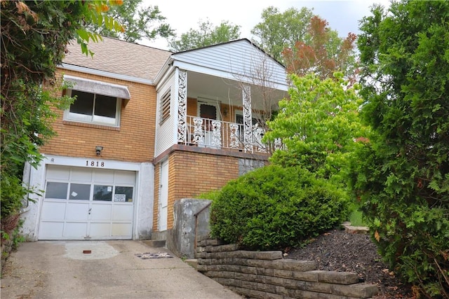 1818 Bluff St, West Mifflin, PA 15122 - view of front of home featuring an attached garage, concrete driveway, brick siding, and roof with shingles