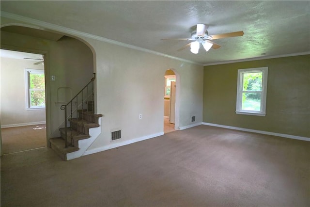1818 Bluff St, West Mifflin, PA 15122 - unfurnished living room featuring arched walkways, a ceiling fan, carpet floors, plenty of natural light, and ornamental molding