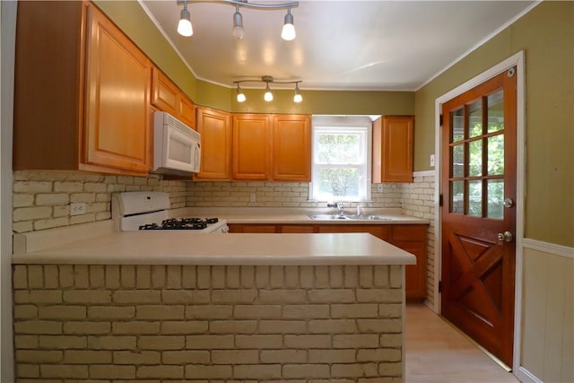 1818 Bluff St, West Mifflin, PA 15122 - kitchen with white appliances, a sink, light countertops, a peninsula, and decorative backsplash