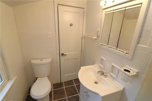 1818 Bluff St, West Mifflin, PA 15122 - bathroom with tile walls, toilet, vanity, and tile patterned flooring