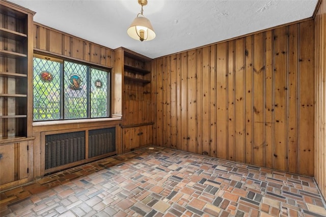 1 Robin Rd, Squirrel Hill, PA 15217 - empty room featuring wood walls and brick patterned flooring
