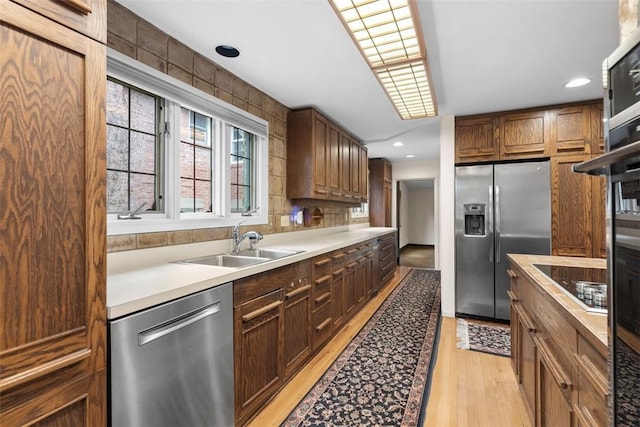 1 Robin Rd, Squirrel Hill, PA 15217 - kitchen with stainless steel appliances, a sink, light wood-type flooring, light countertops, and recessed lighting
