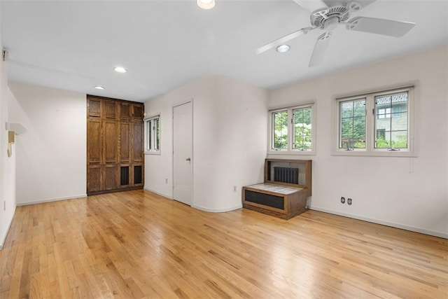 1 Robin Rd, Squirrel Hill, PA 15217 - unfurnished living room with light wood-style flooring, recessed lighting, radiator heating unit, baseboards, and ceiling fan