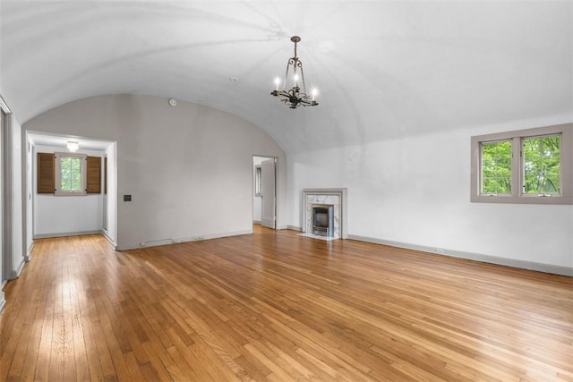 1 Robin Rd, Squirrel Hill, PA 15217 - unfurnished living room with arched walkways, a chandelier, light wood-style flooring, a fireplace, and baseboards