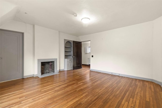 1 Robin Rd, Squirrel Hill, PA 15217 - unfurnished living room with light wood-type flooring, a fireplace with flush hearth, baseboards, and vaulted ceiling
