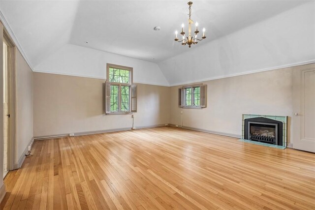 1 Robin Rd, Squirrel Hill, PA 15217 - unfurnished living room with lofted ceiling, light wood-style flooring, a chandelier, healthy amount of natural light, and a fireplace with flush hearth