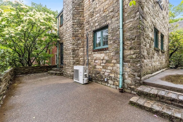 1 Robin Rd, Squirrel Hill, PA 15217 - view of property exterior with ac unit, stone siding, and a patio