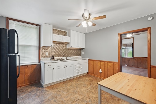 1231 19th Ave, Patterson Twp, PA 15010 - kitchen with freestanding refrigerator, ceiling fan, a sink, white cabinets, and wainscoting
